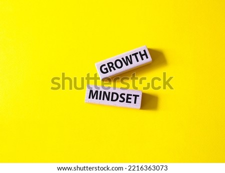 Growth Mindset symbol. Concept word Growth Mindset on wooden blocks. Beautiful yellow background. Business and Growth Mindset concept. Copy space