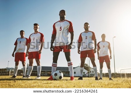 Soccer player, team and sports training on soccer field by men standing with ball, power and strong mindset. Football, fitness and man football players united in support on football field for workout Royalty-Free Stock Photo #2216364261