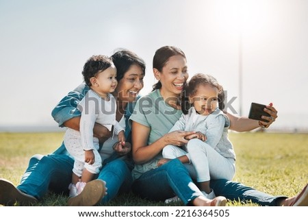 Phone, selfie and family with a woman, girl and sister taking a photograph while enjoying a summer picnic on a field of grass. Love, grandmother and generations with a mother posing for a picture