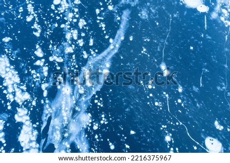 Aerial view of frozen lake. Ice from drone view. Background texture concept. Royalty-Free Stock Photo #2216375967