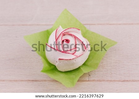 peony shaped cookies on a white wooden table on a white background