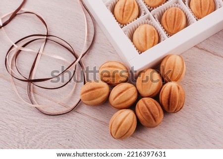 cookie nuts with box on white wooden table