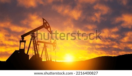 Oil drilling derricks at desert oilfield. The change in oil prices caused by the war. Oil prices are rising.
