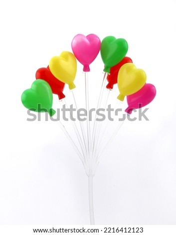 Heart-shaped balloon on white background
