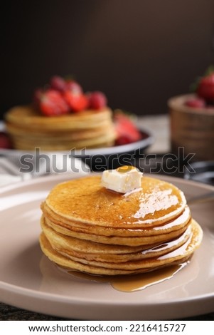 Tasty pancakes with butter and honey on plate, closeup Royalty-Free Stock Photo #2216415727