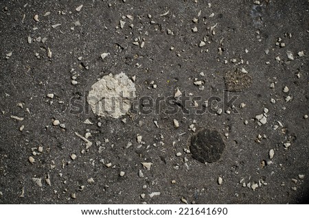 Old bubble gum stuck on a dark pavement background Royalty-Free Stock Photo #221641690