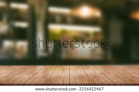 Empty wooden table top with lights bokeh on blur restaurant background.	