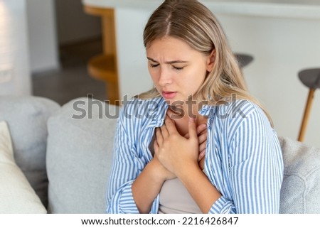 Young woman having chestpain,Acute pain, possible heart attack.Effect of stress and unhealthy lifestyle concept. Royalty-Free Stock Photo #2216426847