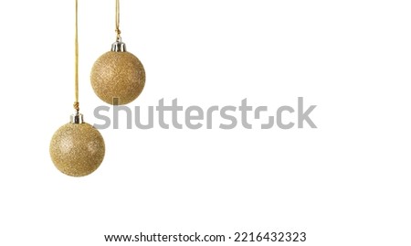 two golden Christmas balls with glitter hanging in front of a white background with space for copy