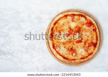 Top view of pizza Margherita on gray surface