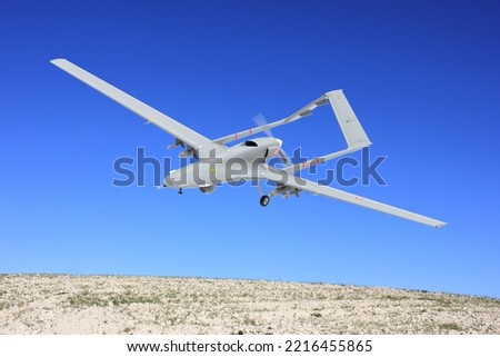 Bayraktar TB2 Unmanned aerial vehicle gliding through the sky. Bayraktar TB2 combat drone in flight over the skies. Royalty-Free Stock Photo #2216455865
