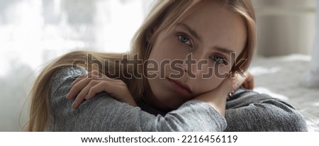 Young caucasian woman is depression and having mental problem in the bedroom at home, emotion and negative, woman loneliness and worry with disappoint, expression and hopelessness, lifestyles concept.