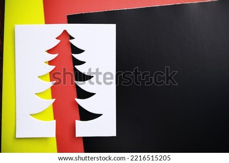 Christmas tree paper cutting design papercraft card. White, red and green color

