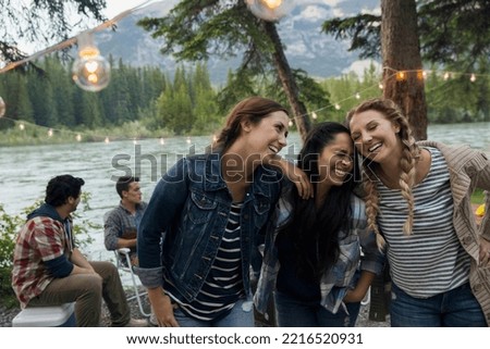 Girls laughing at lakeside campsite