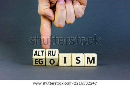 Altruism or egoism symbol. Concept words Egoism and Altruism on wooden cubes. Psychologist hand. Beautiful grey table grey background. Business psychological altruism or egoism concept. Copy space Royalty-Free Stock Photo #2216532247
