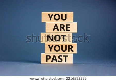 You are not your past symbol. Concept words You are not your past on wooden blocks. Beautiful grey table grey background. Business and you are not your past concept. Copy space.