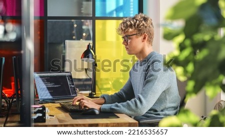 Side View of Male Data Science Intern Writing Lines Of Code on Desktop Computer In Stylish Office. Young Caucasian Man Solving Software Problems for Big Tech Company. Fututre Programmer Learns Coding. Royalty-Free Stock Photo #2216535657