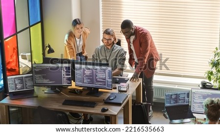 Male CEO and Female CTO Talking to Software Engineer Team Lead In Creative Office Space. Black Entrepreneur and Caucasian Business Partner Offering New Features For Their Innovative Online Service. Royalty-Free Stock Photo #2216535663