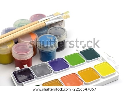 Paints for drawing on a white background. Paint brushes.