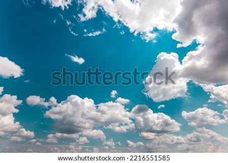 Blue sky background with Cumulonimbus and Cirrostratus clouds.  Sunny Travel Day, view from below. Cumulus sky. Meteorology, Climate Travel Vacation Concept. Royalty-Free Stock Photo #2216551585