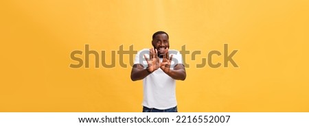 Portrait shock and annoyed displeased young man raising hands up to say no stop right there isolated orange background. Negative human emotion, facial expression, sign, symbol, body language.