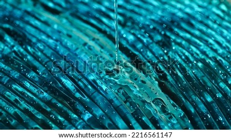 Close up view of blue hydrogel pouring on textured surface 