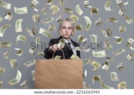 Concept photo of a woman with paper bag standing under money rain.