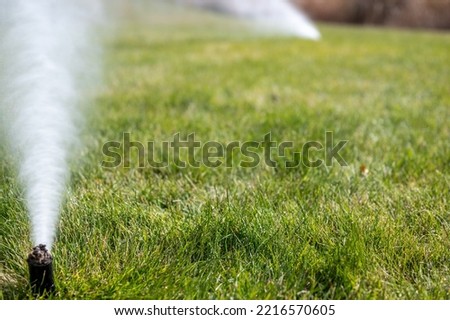 winterizing a irrigation sprinkler system by blowing pressurized air through to clear out water Royalty-Free Stock Photo #2216570605