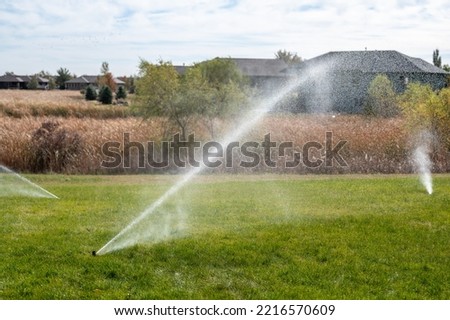 winterizing a irrigation sprinkler system by blowing pressurized air through to clear out water Royalty-Free Stock Photo #2216570609