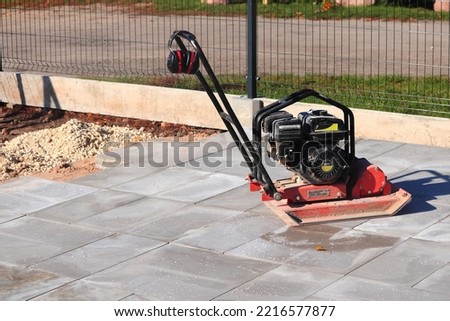 Machine for compacting paving stones. Compactor Royalty-Free Stock Photo #2216577877
