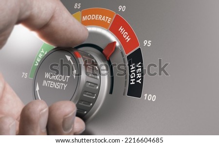 Man turning workout knob to high level. HIIT workout, High Intendsity Interval Training concept. Composite image between a hand photography and a 3D background. Royalty-Free Stock Photo #2216604685