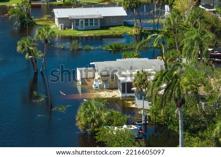 Surrounded by hurricane Ian rainfall flood waters homes in Florida residential area. Consequences of natural disaster Royalty-Free Stock Photo #2216605097