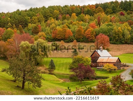 Wooden barn among the autumn trees in Sleepy Hollow Farm in Vermont