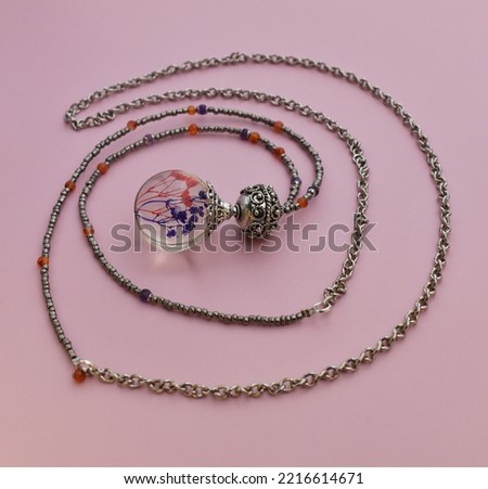 Gemstone beads necklace on pink, unique handmade jewelry background