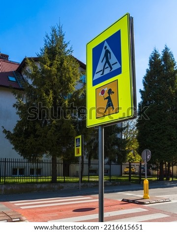 Road signs pedestrian crossing and children attention in Poland on the road in Krakow on a sunny day. Polish road signs. Vertical Orientation