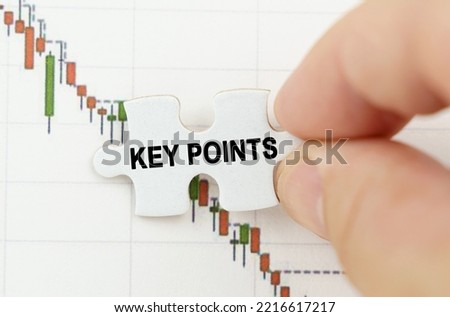 Business concept. Against the background of the quotes chart, a puzzle with the inscription - KEY POINTS