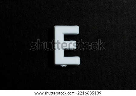 Letter E on a black background Royalty-Free Stock Photo #2216635139