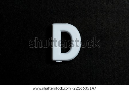 Letter D on a black background Royalty-Free Stock Photo #2216635147