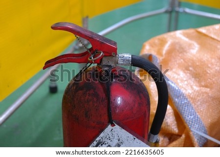 fire extinguisher covered in black ash