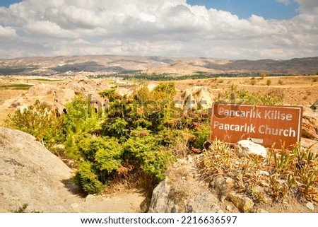 Pancarlik church sign with view to buildings in valley of churches