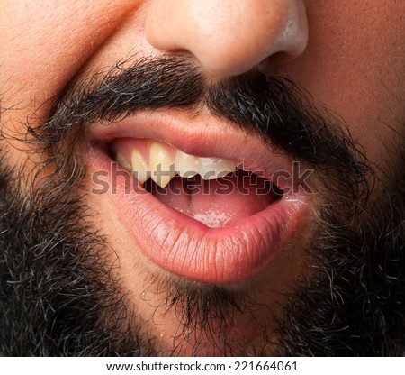 young crazy bearded man. mouth close up