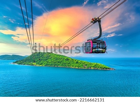 View of longest cable car ride in the world, Phu Quoc island, Vietnam, sunset sky. Below is seascape with tropical islands and boats. Royalty-Free Stock Photo #2216662131