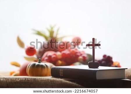 Church Thanksgiving Day bountiful fruit decoration and background with bible and jesus cross
