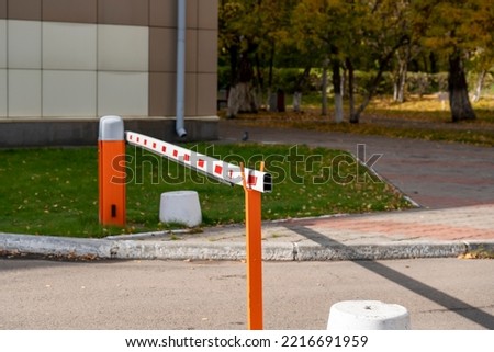 Car barrier to private territory. White barrier with red markings on orange posts.