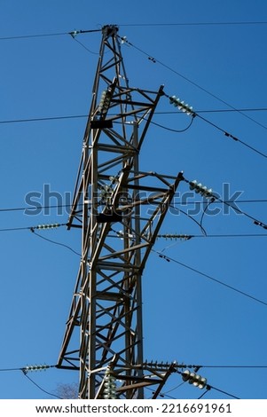 Metal electric tower with wires on the background of a blue sky. Power supply.