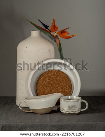 Morning still life cup with tea, croissant, orange exotic flower
