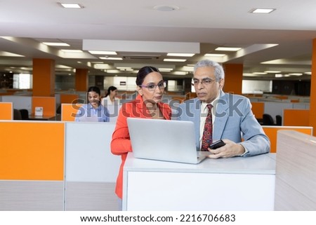 Two senior business colleagues at meeting in modern office