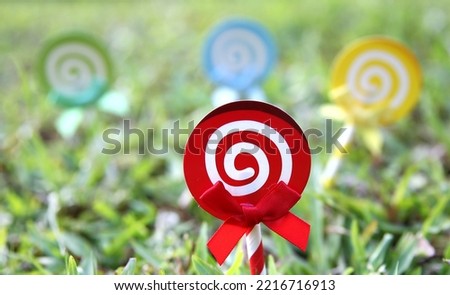 Lollipop candy set, spiral sucker on stick, sugar swirl .  Cartoon sweet lollypop isolated on grass

