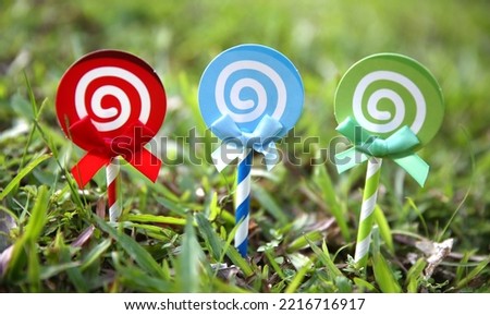 Lollipop candy set, spiral sucker on stick, sugar swirl .  Cartoon sweet lollypop isolated on grass
