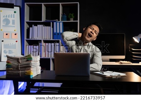 Yawn, burnout and tired businessman is sleepy in the office from deadlines, overworked and overwhelmed with fatigue. Mental health, yawning and exhausted black man working overtime on his computer. Royalty-Free Stock Photo #2216733957